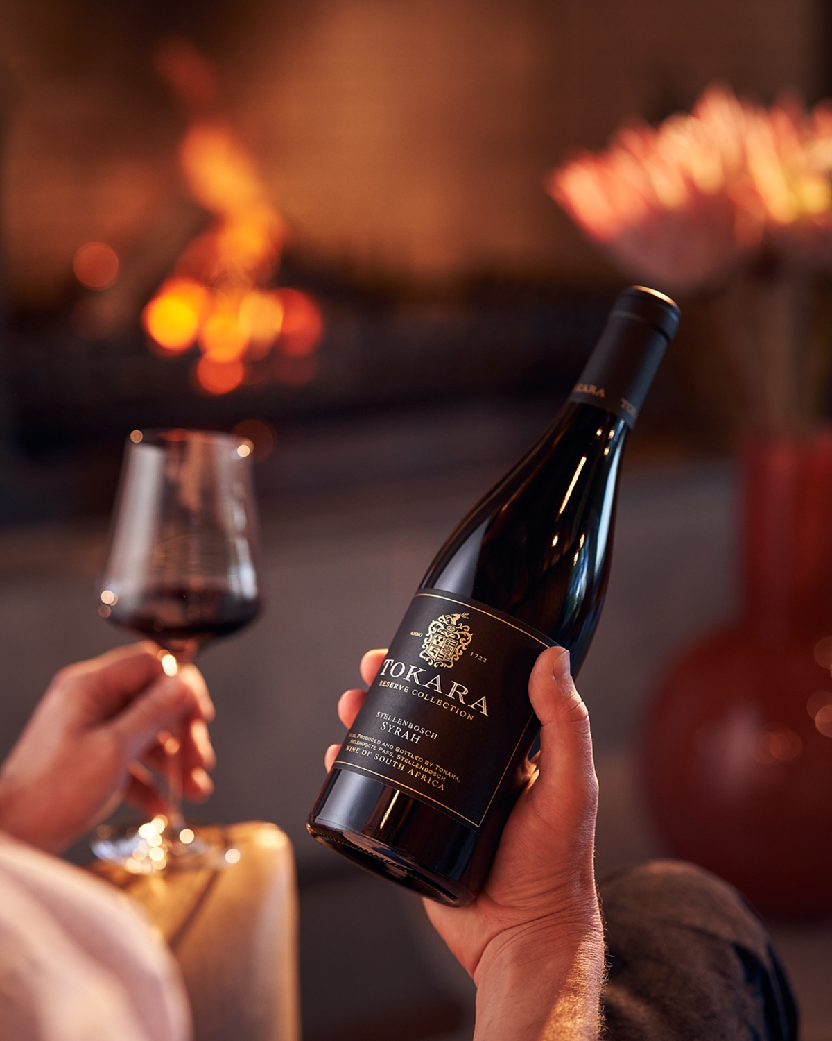 Eine Flasche Tokara Reserve Collection Syrah Wein aus Stellenbosch, Südafrika, mit einem schwarzen Etikett mit goldenem Text und einem goldenen Wappen.